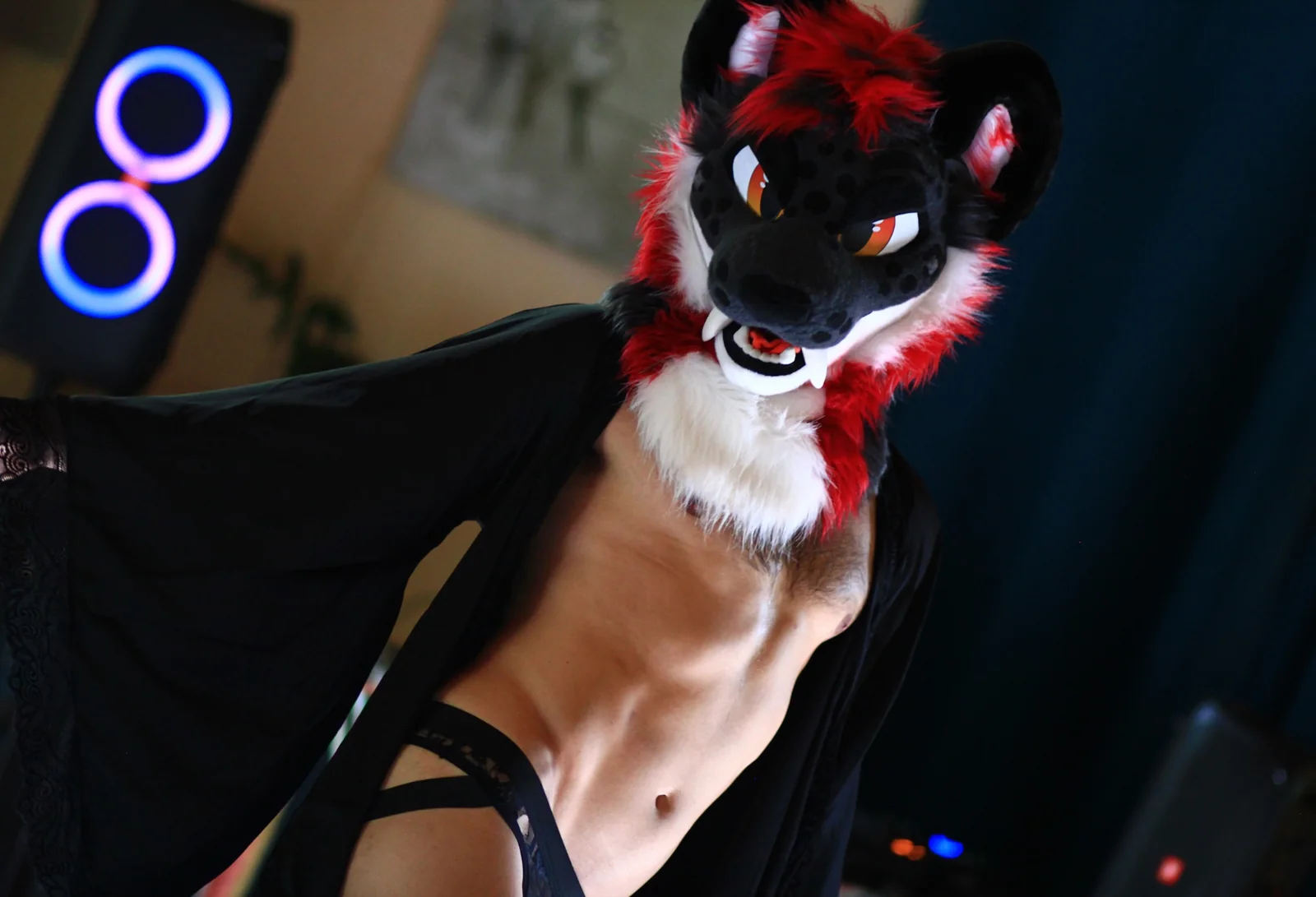 Scorch posing in a black robe and fursuit head